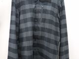 the shirt is black and grey with a checkered pattern on it