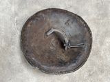 a metal plate with a handle on the concrete floor