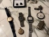 a lot of watches that are sitting on a table