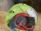 a green hose with a red cord attached to it