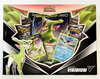 La boîte contient toute une série de cartes Pokémon, dont un Pokémon à tête verte.
