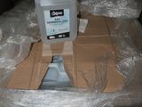 a container of liquid sitting on top of a cardboard box