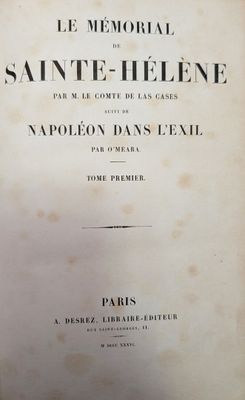 an old book sitting on top of a wooden table next to a window