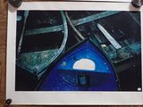 a picture of a blue boat on a wooden floor