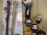 a few harry potter items on the table next to a pen and a keychain