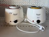 two toasters that are sitting on a shelf next to each other