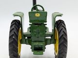 a toy tractor that is sitting on a white surface