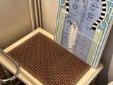 a toilet with a seat that has a picture of a door on it