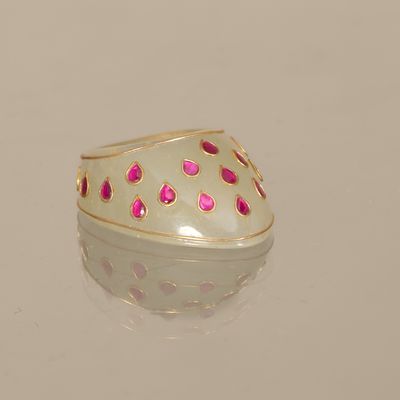 a white ring with pink dots on it