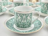 several cups and saucers are lined up on a table