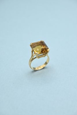 a gold ring with a citrine stone in the center