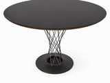 une table ronde avec un plateau noir et un piètement en métal