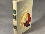 a white book with a red and yellow design on the cover