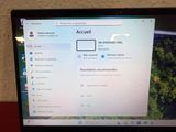 laptop screen with a picture of a forest on the screen and an arrow pointing to the right