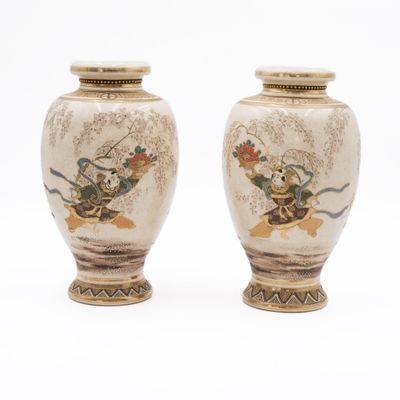 two vases that are sitting on a white surface
