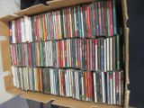 a cardboard box filled with many different cd ' s