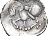 an old silver coin with an image of a man and a dog on it