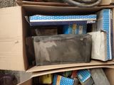 a box full of assorted items sitting on the ground