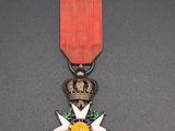 an image of a medal with a red ribbon on a table