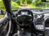 the interior of a car with a steering wheel, dashboard, and dashboard controls