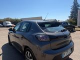 the back of a grey car parked in a parking lot