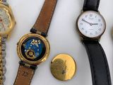many different types of watches on a white surface