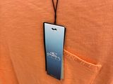 an orange shirt with a cell phone attached to it ' s chest