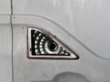 a close up of a car ' s door with a spiral design on it
