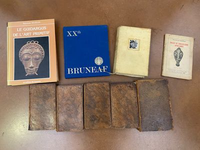 several books are sitting on a table next to a pair of scissors