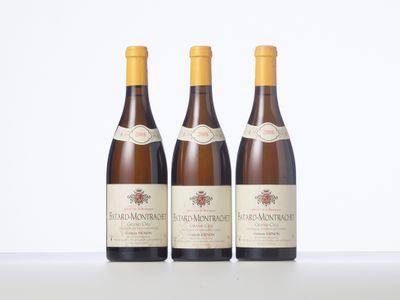 three bottles of wine sitting on top of a white table