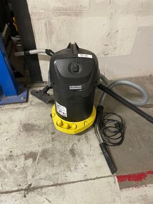 a yellow and black vacuum sitting on the floor