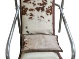 brown and white cowhide lounge chair with metal frame