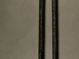 a pair of baseball bats and a ball on a table