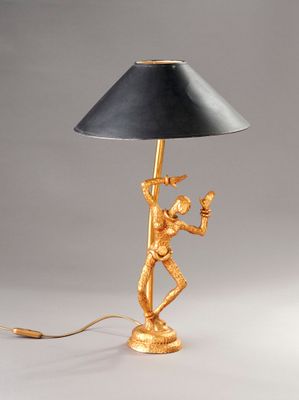 une image représentant une lampe dorée munie d'un abat-jour noir