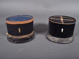 pair of black hats with gold trims on top of each other