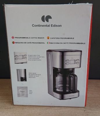packaging of a coffee maker sitting on top of a wooden table