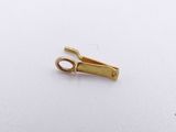 a small piece of gold that is on a white surface
