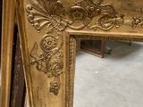 an image of a gold frame sitting on top of a pile of boxes