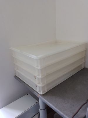 a stack of plastic containers sitting on top of a table