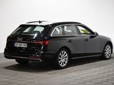 the rear end of a black audi wagon parked on a checkered floor