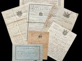 a pile of old letters and papers on a black background