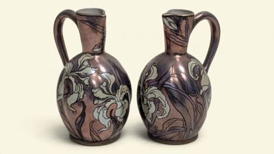 two vases sitting side by side on a white surface