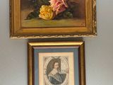 two framed pictures of flowers hang on a wall in a room