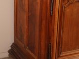 a wooden cabinet with a marble top in a room