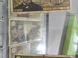 a glass display case with three different bills in it