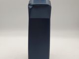 a blue plastic bottle with a black cap on a white surface