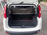 a white car with its trunk open in a parking lot