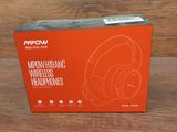 a box of headphones sitting on top of a wooden table