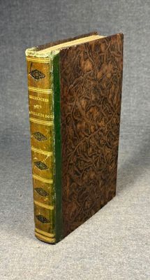 a brown book with green trim sitting on top of a table