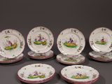 seven pieces of porcelain plates with flowers and birds painted on them